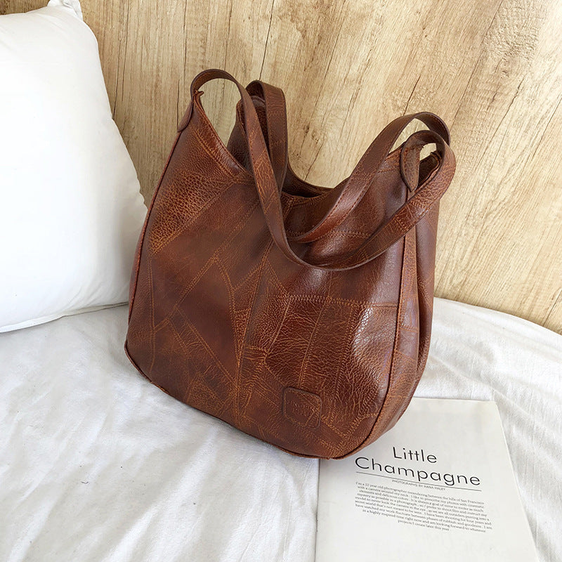 Damen Handtasche mit geschwungenem Design und hochwertiger Lederstruktur Nord Taschen