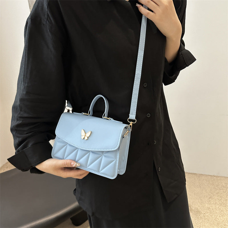 Damen elegante Handtasche mit Quermuster und stylischem Schmetterling Nord Taschen