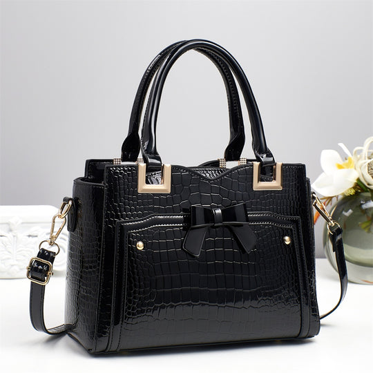 Damen elegante Handtasche mit dekorativem Schleifen-Detail und strukturiertem Krokodil-Leder-Look Nord Taschen