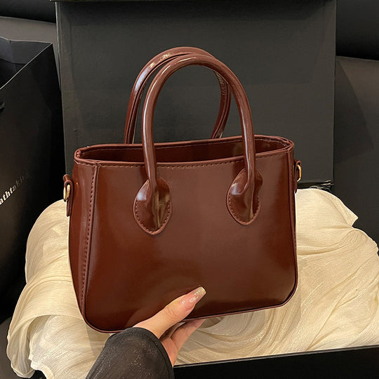 Damen elegante Handtasche aus glänzendem Kunstleder Nord Taschen