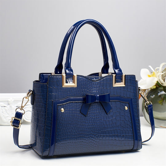 Damen elegante Handtasche mit dekorativem Schleifen-Detail und strukturiertem Krokodil-Leder-Look Nord Taschen
