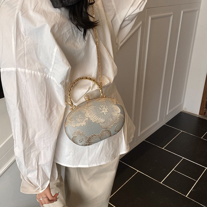 Damen Clutch mit floralem Muster und goldenen Akzenten Nord Taschen