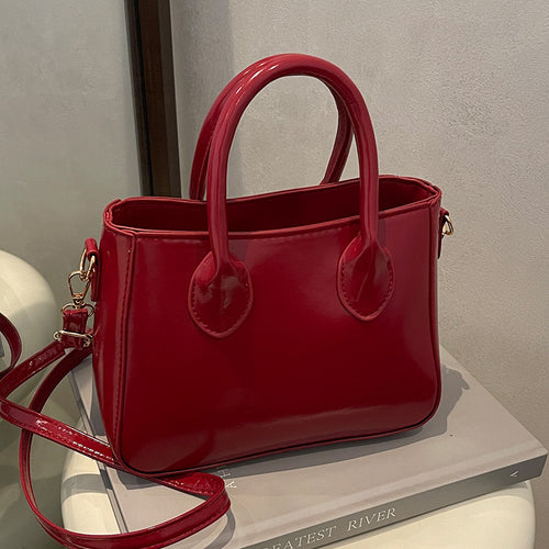 Damen elegante Handtasche aus glänzendem Kunstleder Nord Taschen