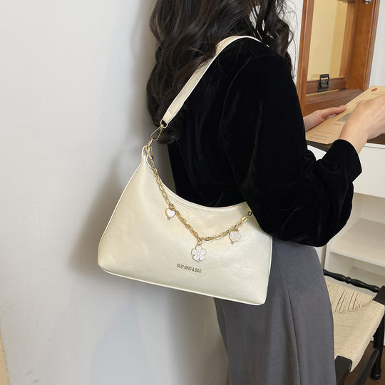 Damen Umhängetasche mit elegantem Ketten-Design und floralem Akzent Nord Taschen